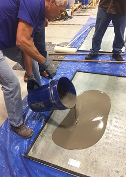 Pete Trainor, VP Sales at PENETRON Specialty Products, shows how easy it is to pour the LEVELINE self-leveling underlayment to a floor surface